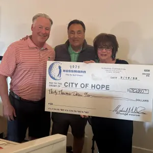 Tim Ryan, Michael Nobile presented a check for $30,000 to City of Hope's Cheryl Kennick.