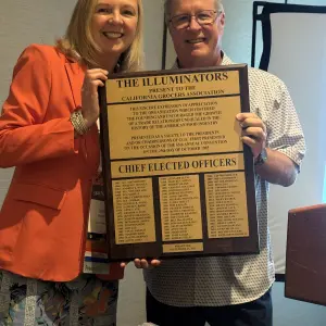 Lori Brown, Headlite of the Illuminators presented a plaque to Richard Wardwell, Superior Grocers for being the next president of CGA 2026