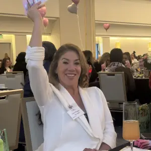 Gerri Pompa, Amor Salsita, raising her hand to make a 12 month pledge to support Olive Crest.