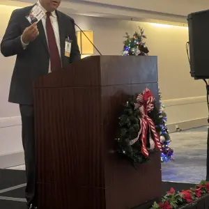 Billy Brink speaking on behalf of Olive Crest and the great work they do, asking for donations.