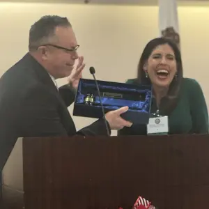 Michael Aquilina passing the gable to Liz incoming President of FISMC