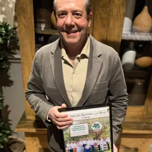 Oscar Gonzalez with a plaque presented to him by The Shelby Report