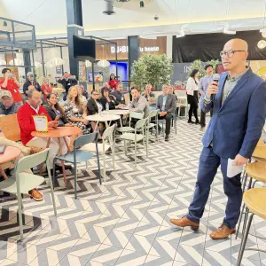 Yijia Lu, Associate Directo of Merchandising speaking to the group