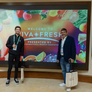 Attendees in Front of Viva Fresh LED Welcome Sign.jpg