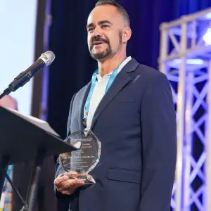 Mt. Olive Pickle Co. National Sales Manager Chad Marsh accepted the company's Outstanding Local Supplier of the Year award.