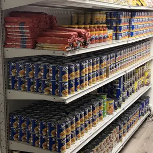Next to the kitchen is a storage area with donated food products from familiar manufacturers