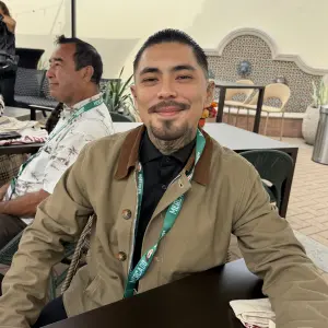 Kris Aguilar, local artist that painted the mural above the deli case depicting the small town the Gonzalez family grew up in.